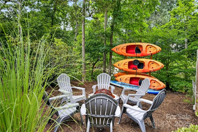 a view of a chairs and table on the wooden deck