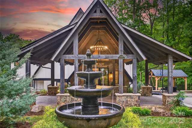 an aerial view of residential houses with outdoor space and lake view