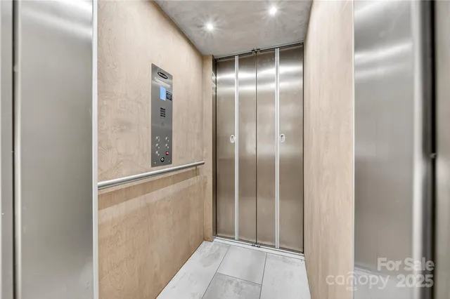 a kitchen with stainless steel appliances kitchen island granite countertop a refrigerator a stove top oven a sink dishwasher and white cabinets with wooden floor