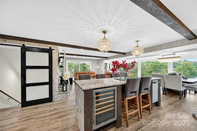 a kitchen with stainless steel appliances granite countertop a sink dishwasher stove and refrigerator