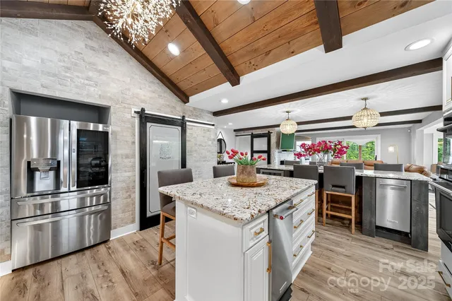 a kitchen with granite countertop a sink stove and cabinets