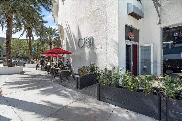 a view of a patio with table and chairs under an umbrella