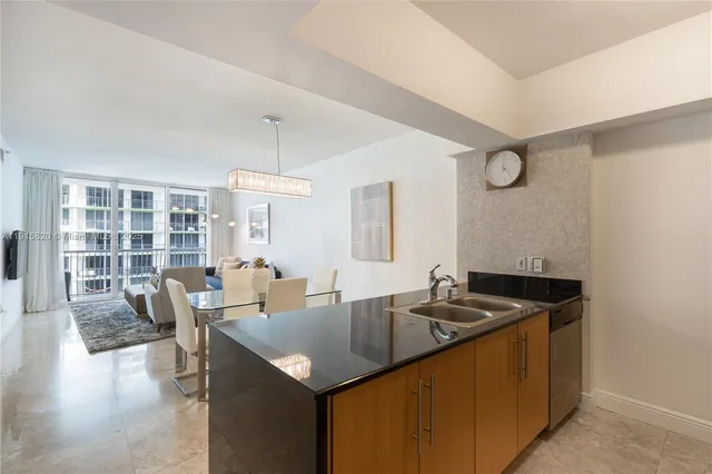 a kitchen with granite countertop a sink and cabinets