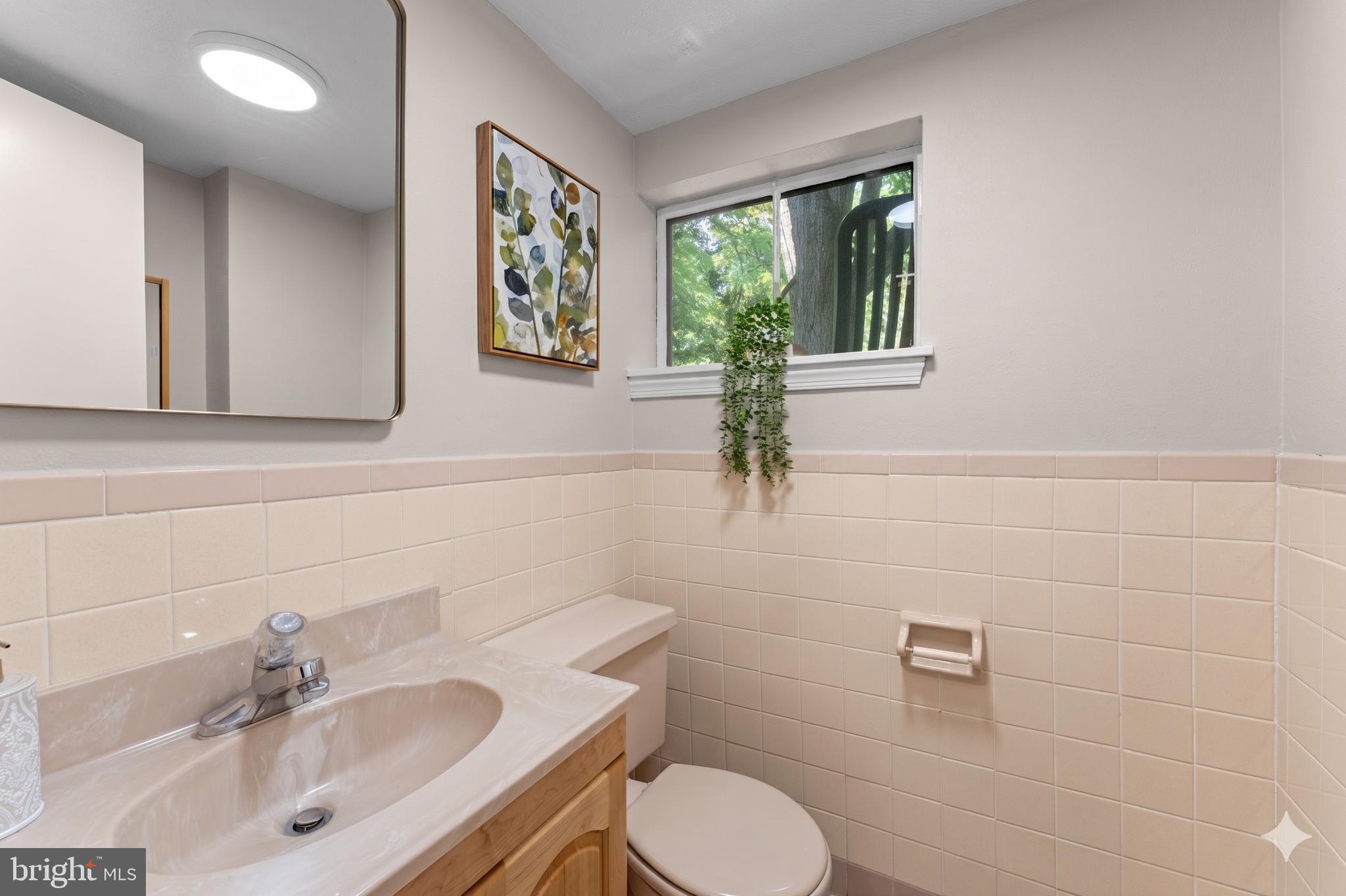 11712 Berwick Road Silver Spring, MD 20904 - Photo 21 of 42 a bathroom with a toilet sink and mirror