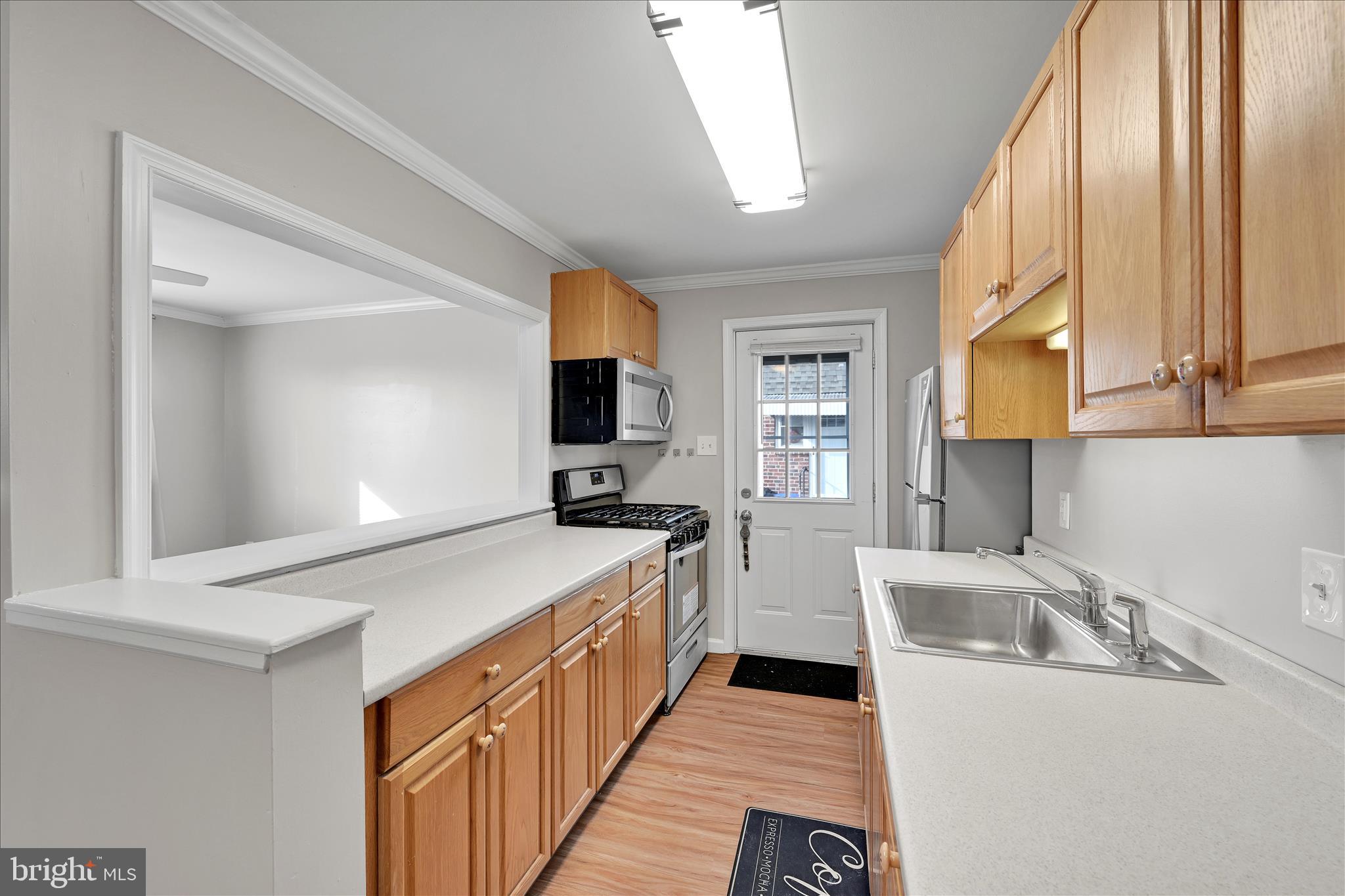 204 Ridley Avenue Folsom, PA 19033 - Photo 11 of 30 a kitchen with a stove a sink and a microwave