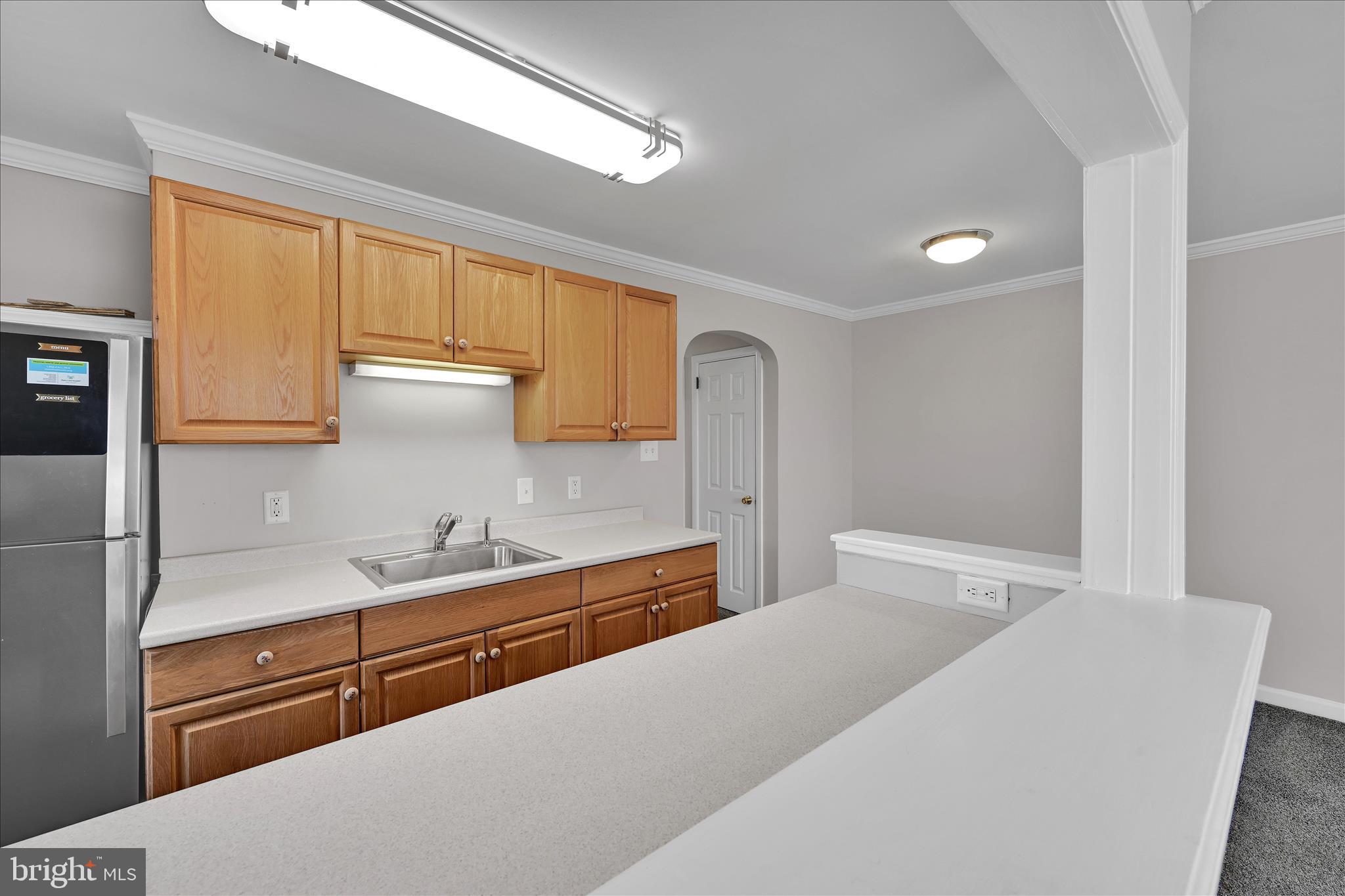 204 Ridley Avenue Folsom, PA 19033 - Photo 12 of 30 a kitchen with a sink and a refrigerator