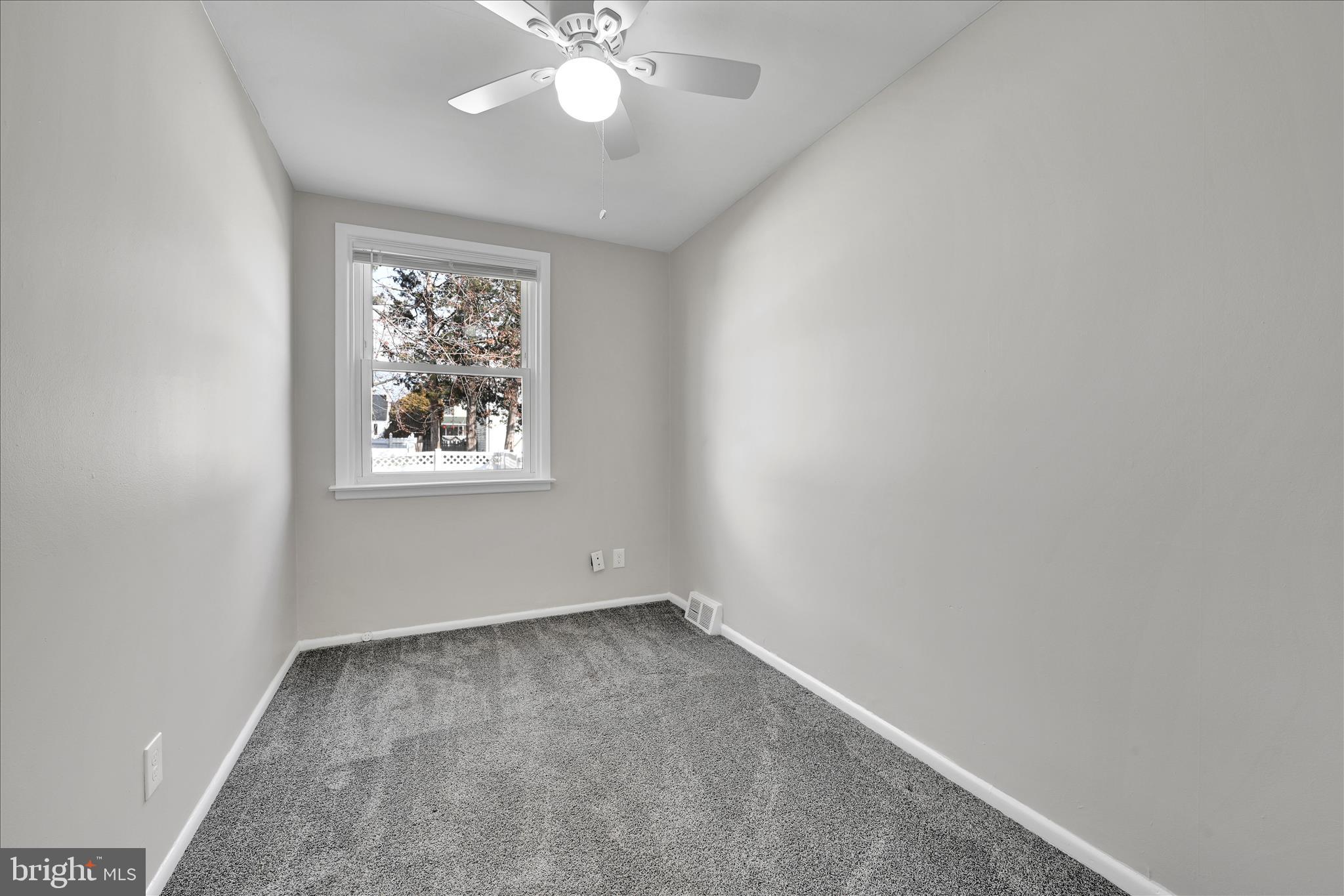 204 Ridley Avenue Folsom, PA 19033 - Photo 18 of 30 an empty room with a chandelier fan and windows