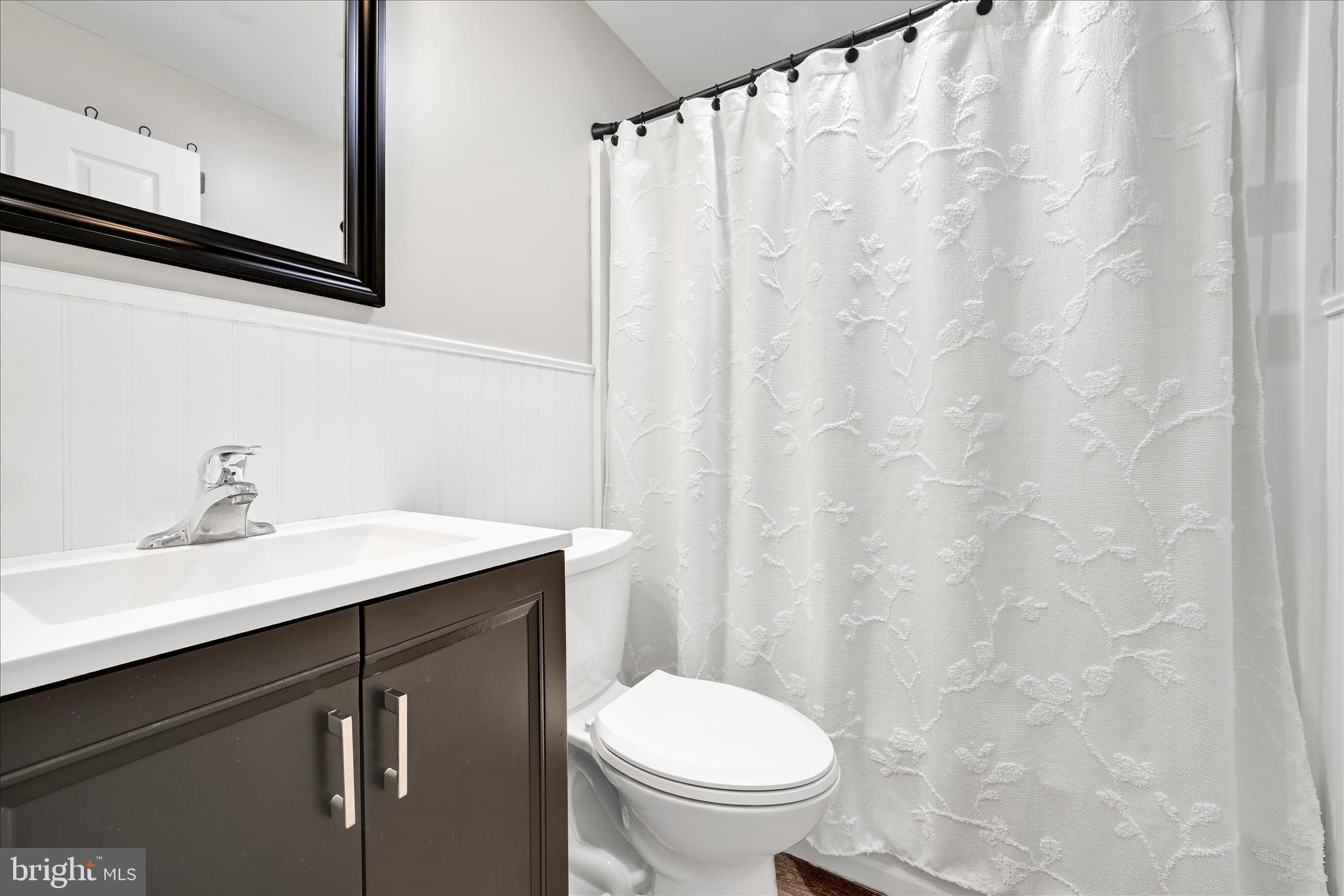 204 Ridley Avenue Folsom, PA 19033 - Photo 20 of 30 a bathroom with a sink a toilet and a mirror