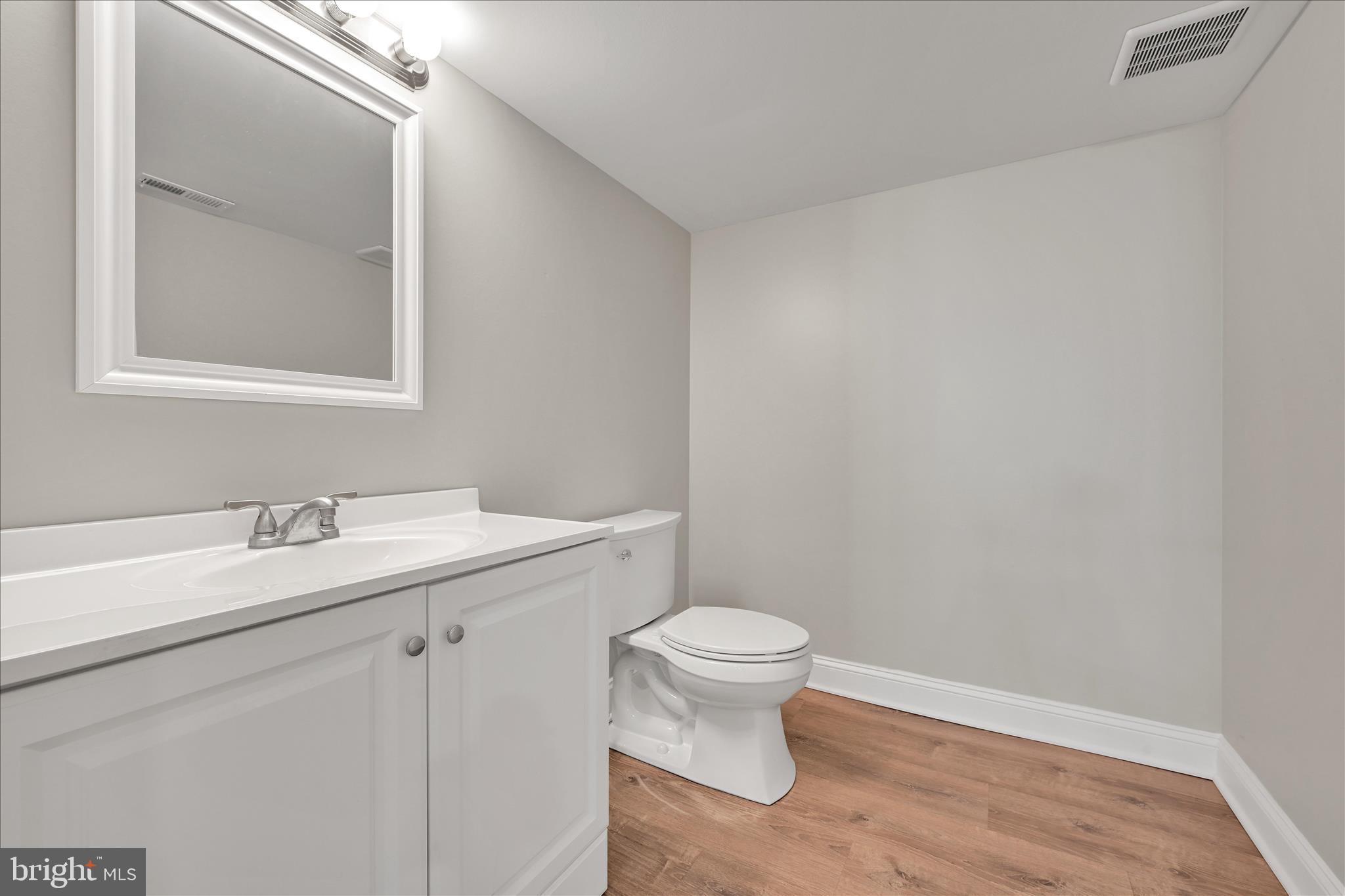 204 Ridley Avenue Folsom, PA 19033 - Photo 24 of 30 a bathroom with a toilet a sink a mirror and vanity