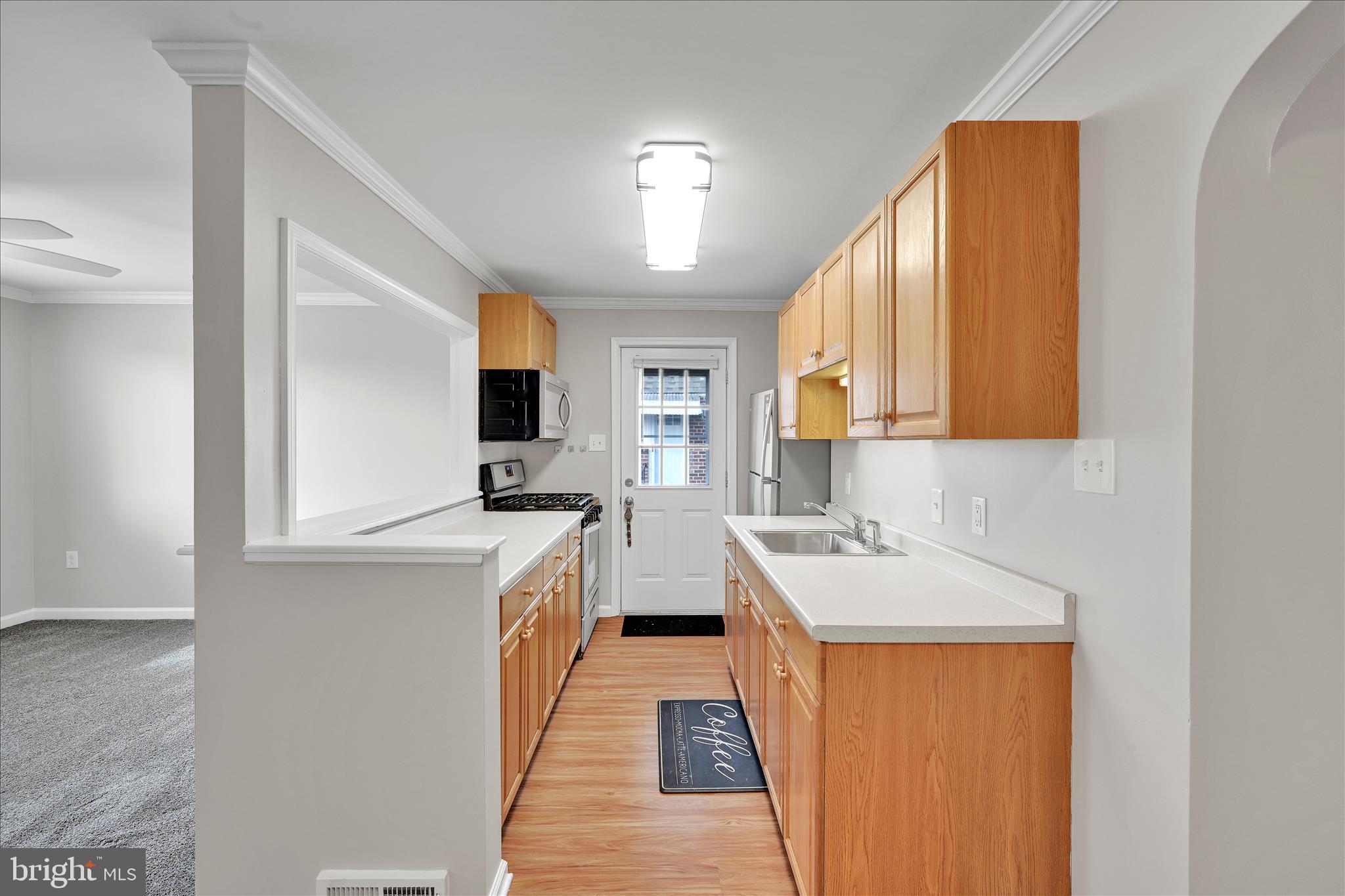 204 Ridley Avenue Folsom, PA 19033 - Photo 10 of 30 a kitchen with a sink stove and refrigerator
