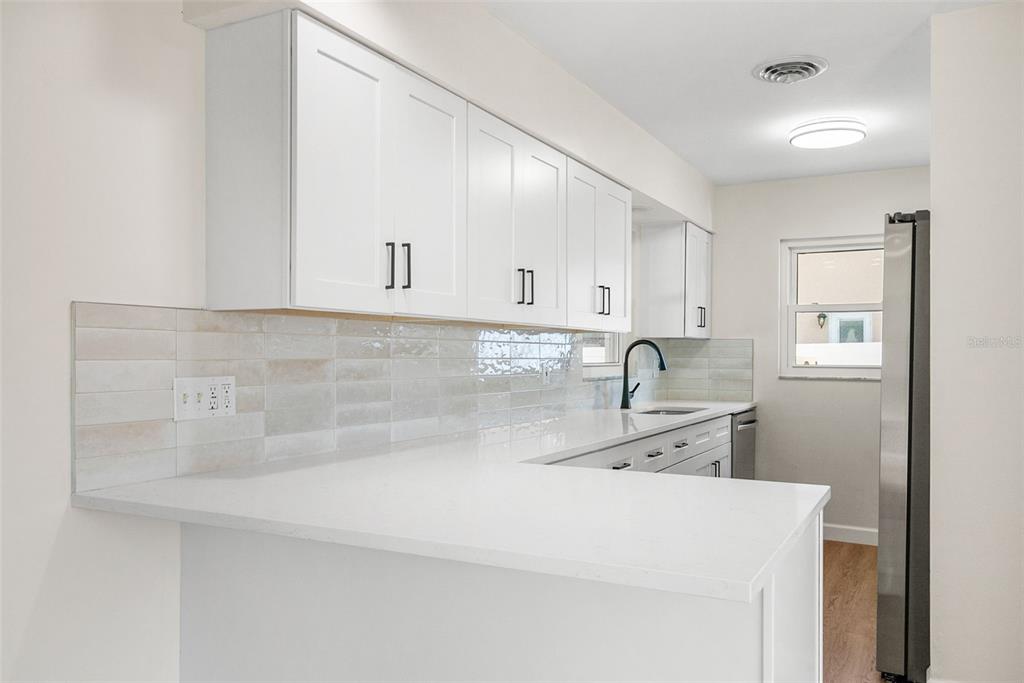 354 Burke Road Venice, FL 34293 - Photo 11 of 34 a view of a kitchen with sink cabinets and appliances