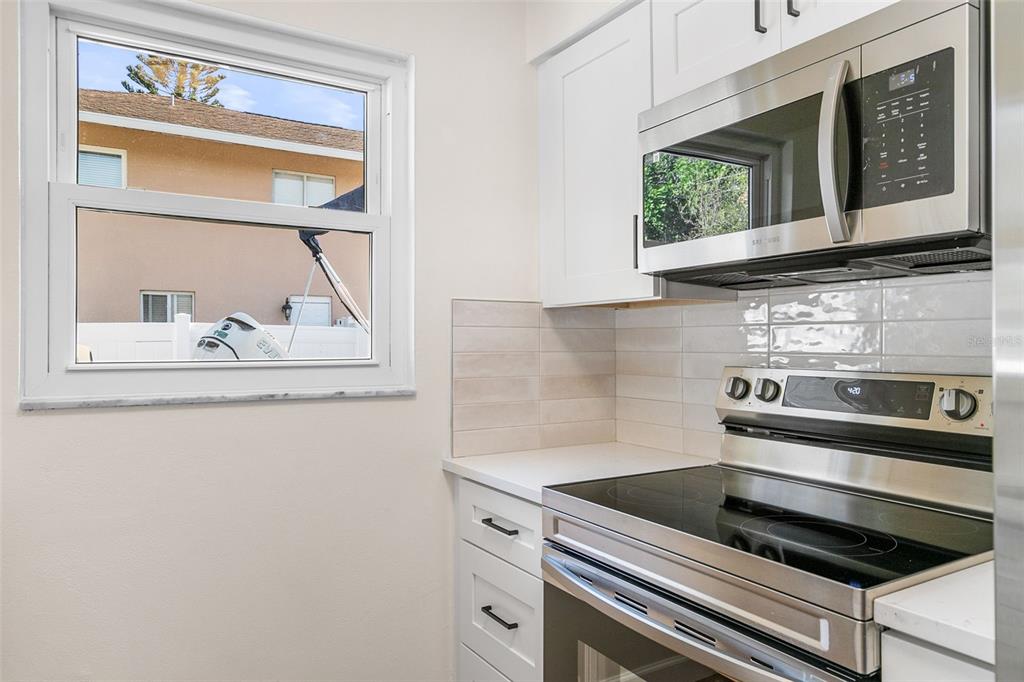 354 Burke Road Venice, FL 34293 - Photo 12 of 34 a kitchen with wooden cabinets and a stove top oven