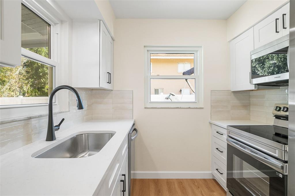 354 Burke Road Venice, FL 34293 - Photo 15 of 34 a kitchen with a sink and a stove top oven