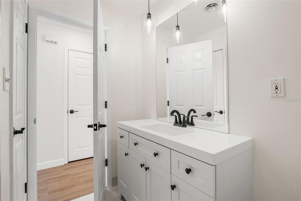 354 Burke Road Venice, FL 34293 - Photo 20 of 34 a bathroom with a sink a mirror a vanity and a shower