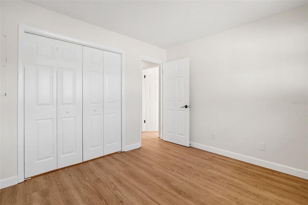 354 Burke Road Venice, FL 34293 - Photo 24 of 34 a view of an empty room with wooden floor