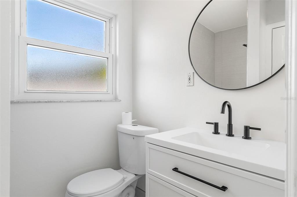 354 Burke Road Venice, FL 34293 - Photo 28 of 34 a bathroom with a toilet a sink and mirror