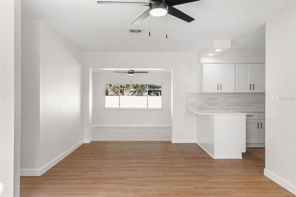 354 Burke Road Venice, FL 34293 - Photo 6 of 34 a view of an empty room with window and wooden floor