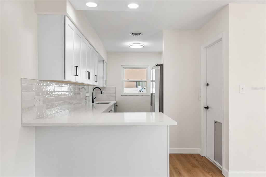 354 Burke Road Venice, FL 34293 - Photo 10 of 34 a kitchen with stainless steel appliances granite countertop a sink and cabinets
