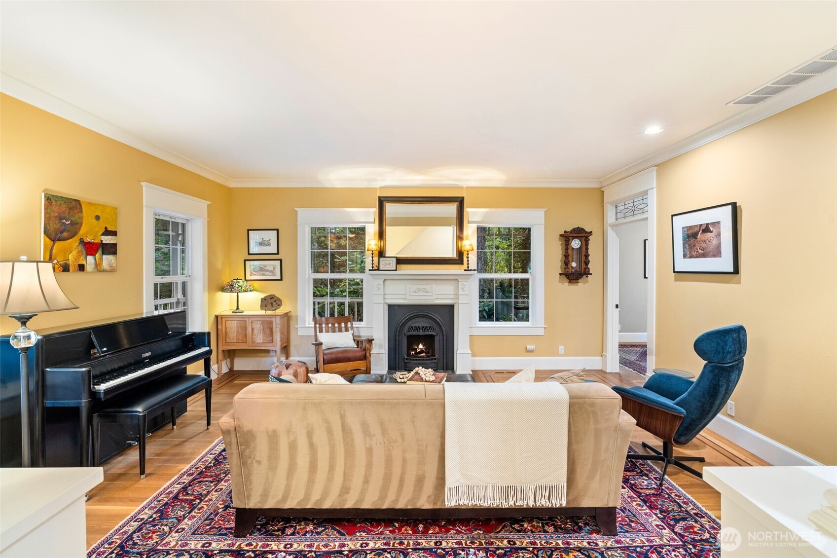 8991 Springwood Avenue Northeast Bainbridge Island, WA 98110 - Photo 14 of 36 a living room with furniture a rug and a fireplace