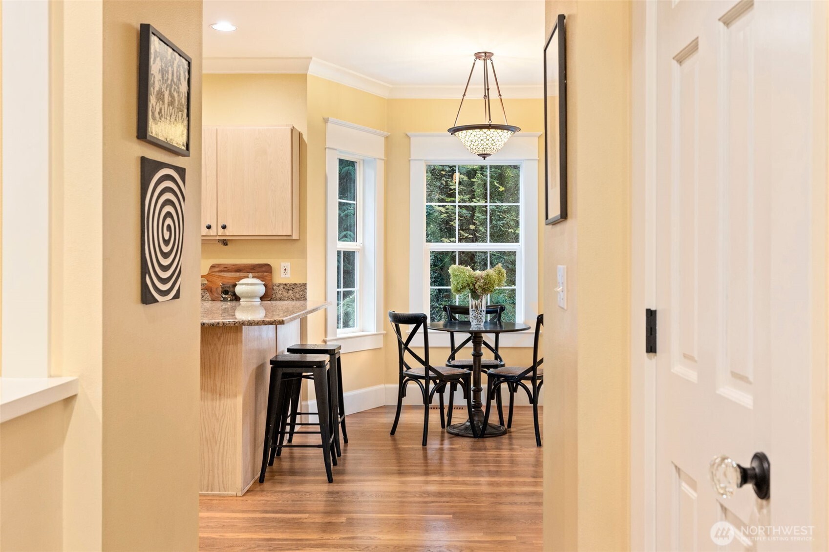 8991 Springwood Avenue Northeast Bainbridge Island, WA 98110 - Photo 16 of 36 a view of a dining room with furniture and wooden floor
