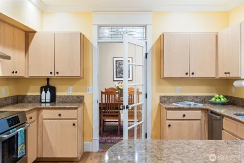 a kitchen with stainless steel appliances a refrigerator sink and cabinets