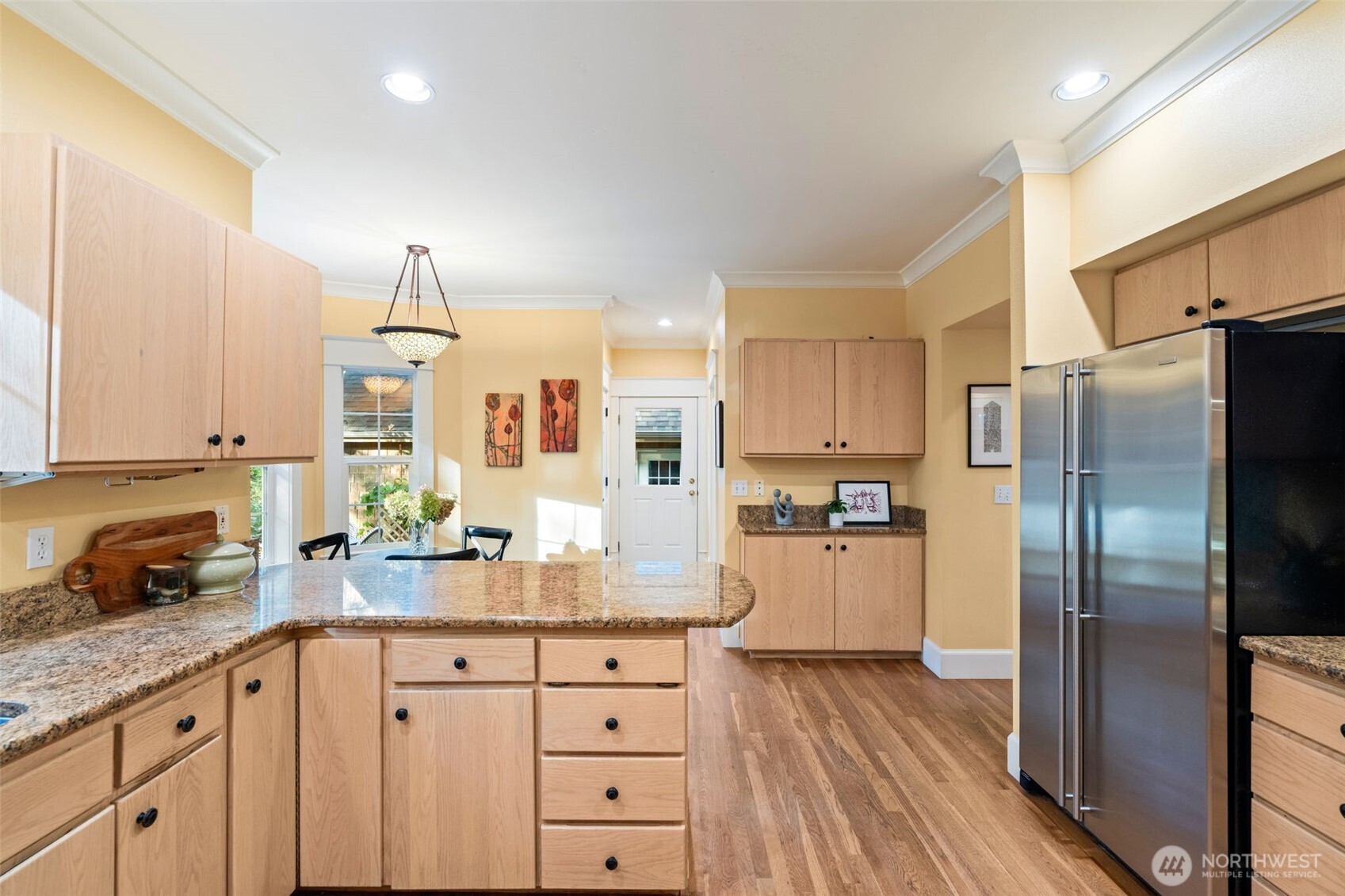 8991 Springwood Avenue Northeast Bainbridge Island, WA 98110 - Photo 20 of 36 a kitchen with stainless steel appliances a refrigerator sink and cabinets