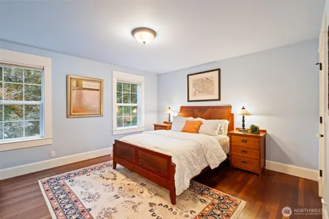 a bathroom with a granite countertop sink a mirror and shower