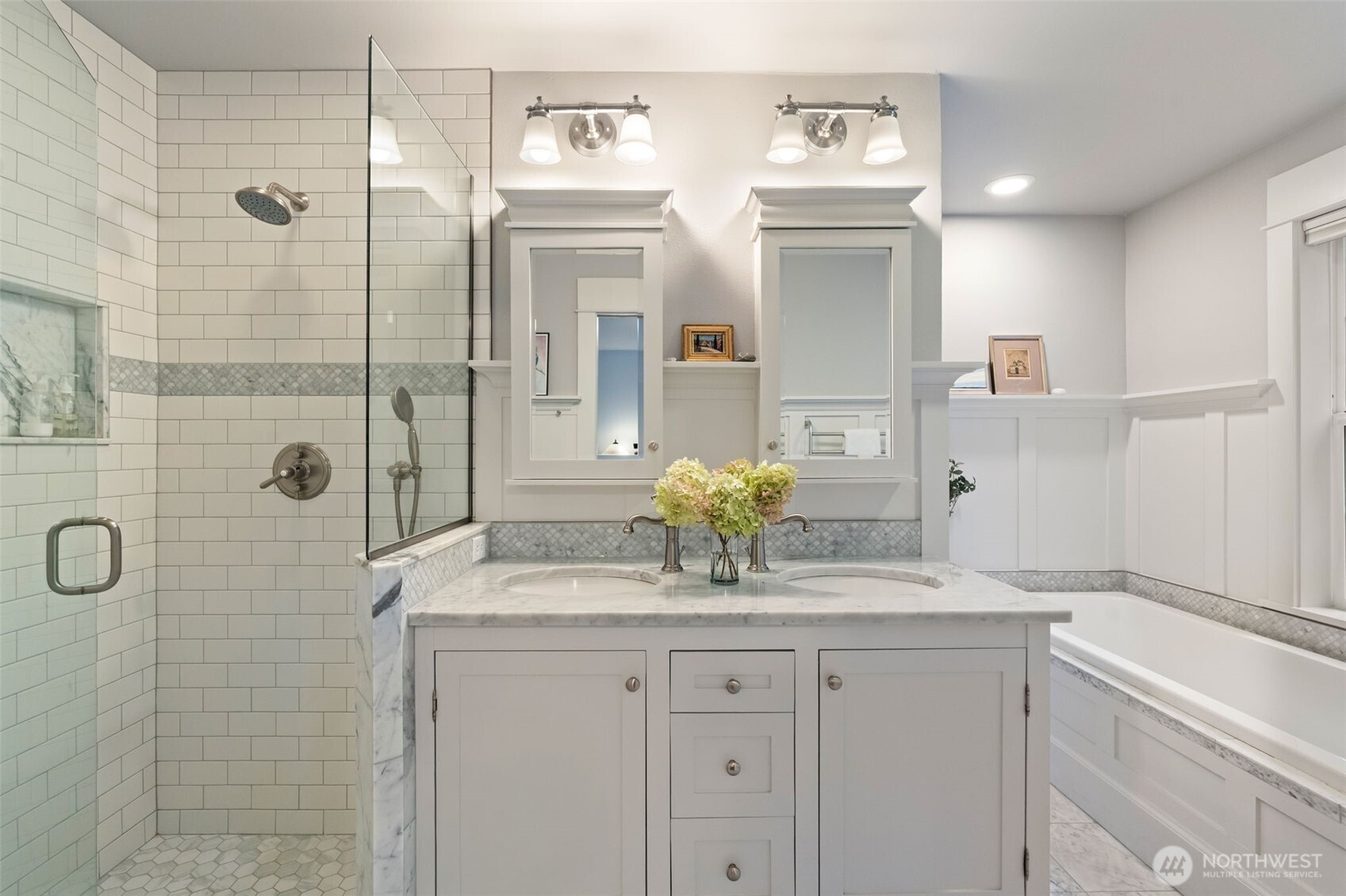 8991 Springwood Avenue Northeast Bainbridge Island, WA 98110 - Photo 26 of 36 a bathroom with a granite countertop sink a mirror and shower