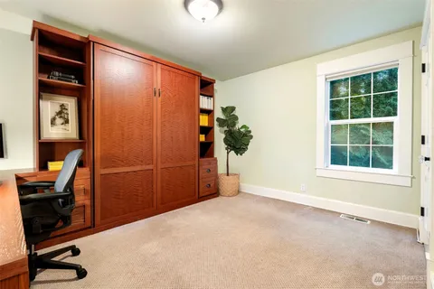 a view of workspace with wooden floor and windows