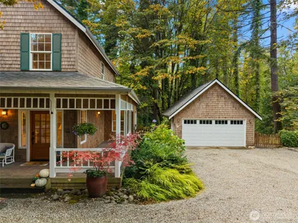 a front view of a house with a yard patio and fire pit