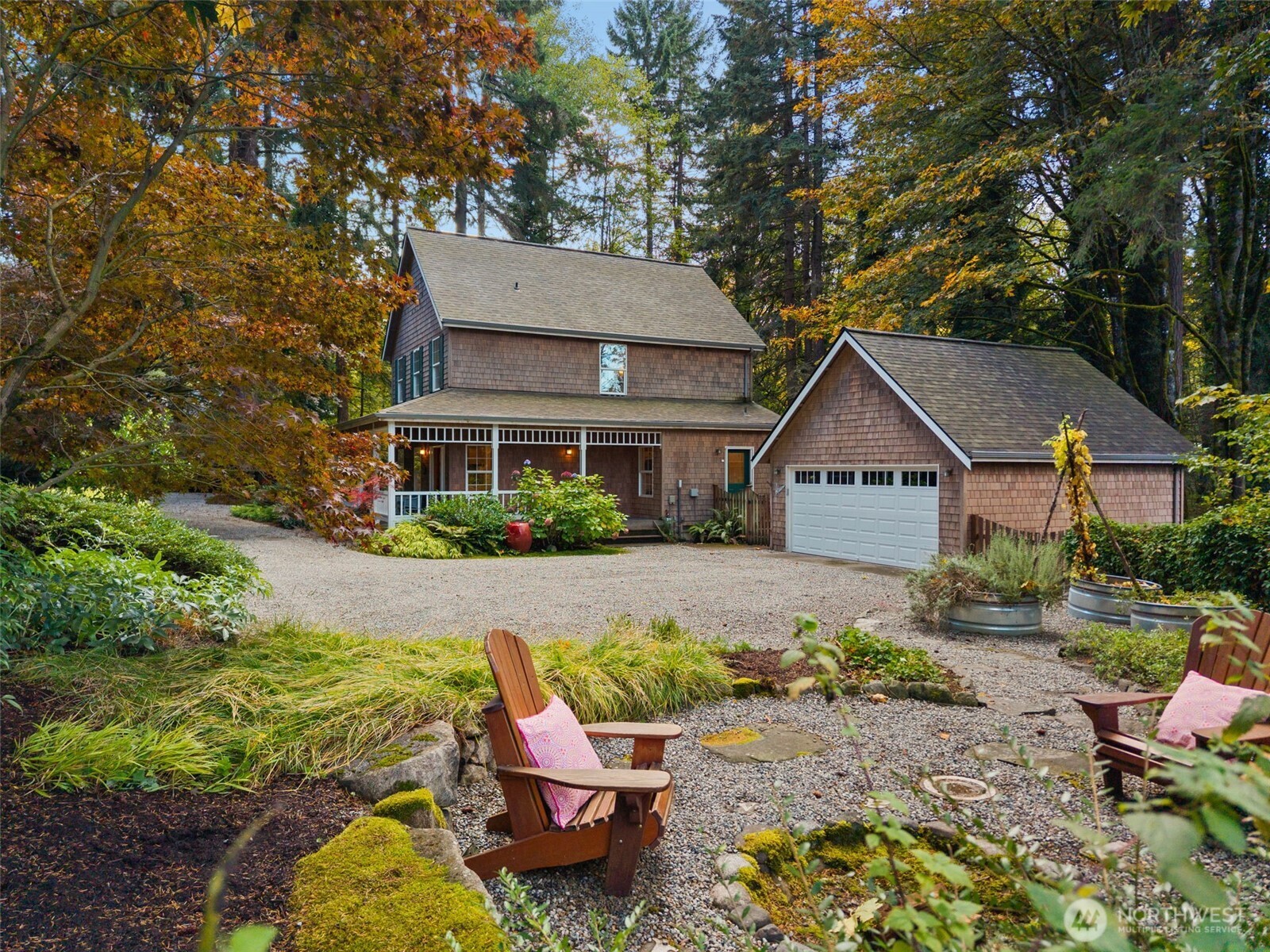 8991 Springwood Avenue Northeast Bainbridge Island, WA 98110 - Photo 7 of 36 a front view of a house with a yard patio and fire pit