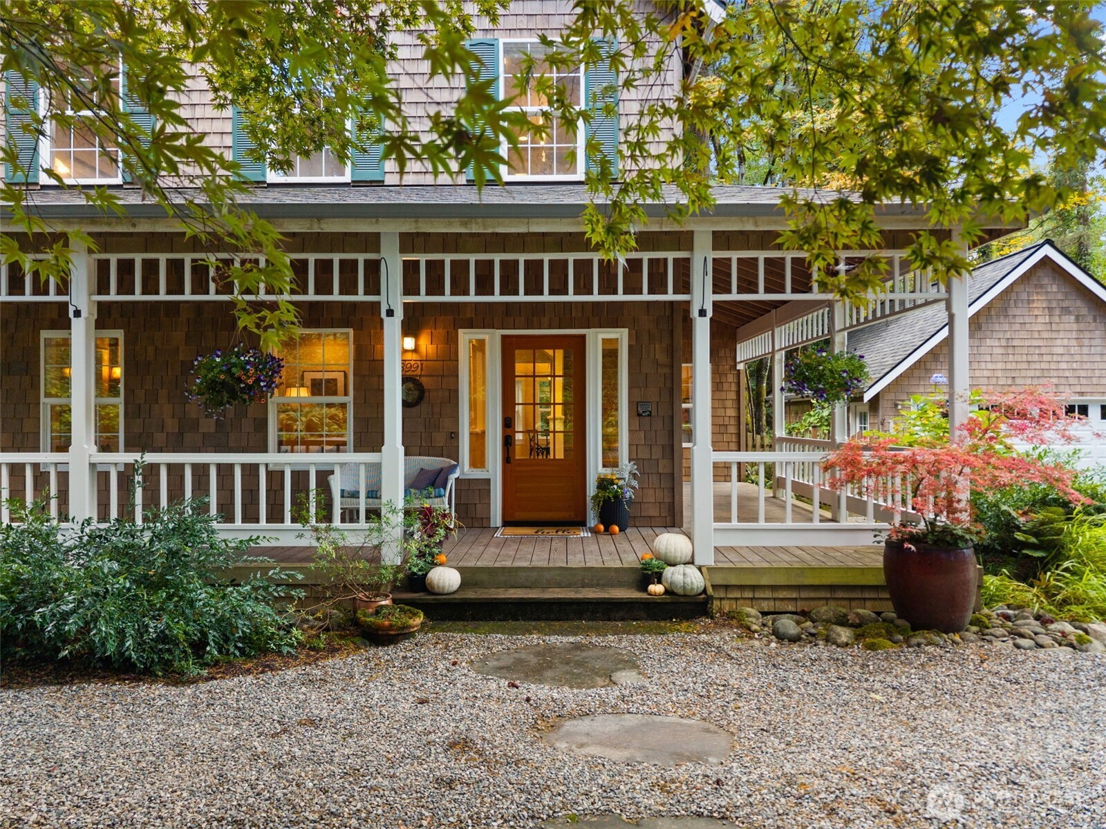 8991 Springwood Avenue Northeast Bainbridge Island, WA 98110 - Photo 9 of 36 front view of a building with a garden
