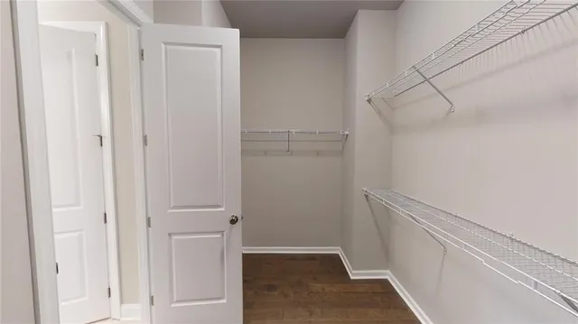 a view of walk in closet with empty racks