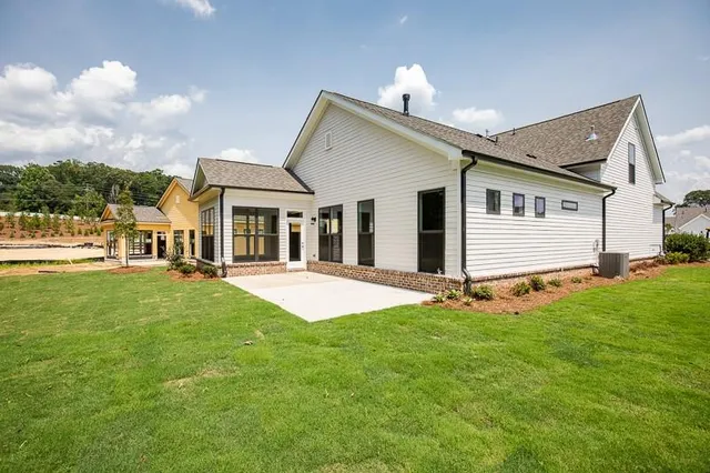 a view of a house with a yard and deck