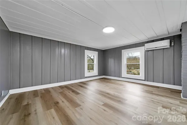a view of room with window and wooden floor