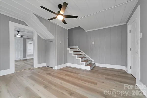 a view of a livingroom with a ceiling fan and window