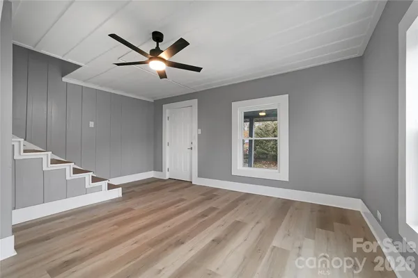 a view of kitchen with stainless steel appliances granite countertop cabinets and wooden floor