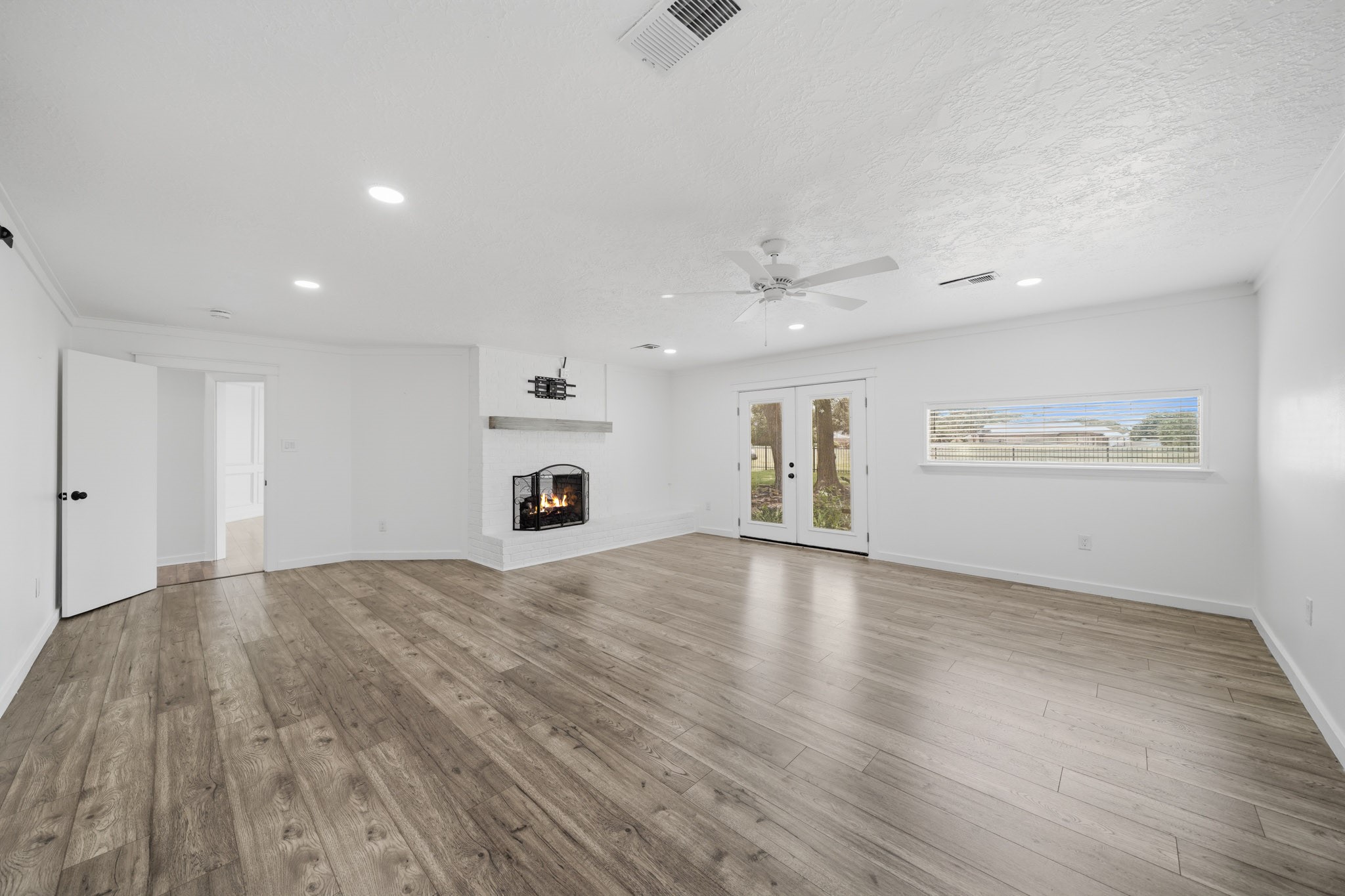 79 Summers Wind Street Conroe, TX 77356 - Photo 19 of 45 a view of an empty room with wooden floor and a window
