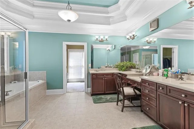 a spacious bathroom with a granite countertop sink a toilet and a mirror