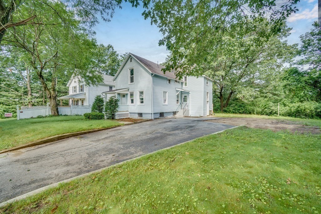 80 Brickett Street Springfield, MA 01119 - Photo 3 of 30 a view of a house with a yard and large trees