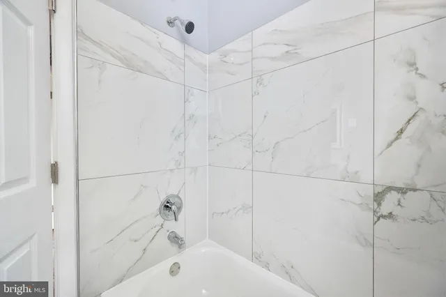 a bathroom with a bathtub and shower