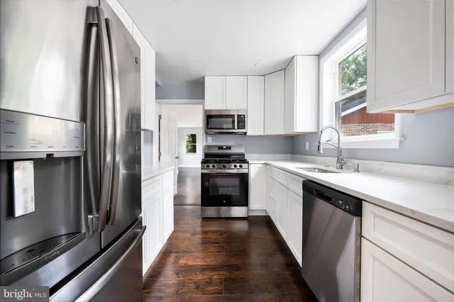 a kitchen with a sink stove and refrigerator