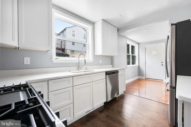 a kitchen with a sink stove and refrigerator