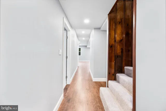 a view of a hallway with wooden floor and glass doors