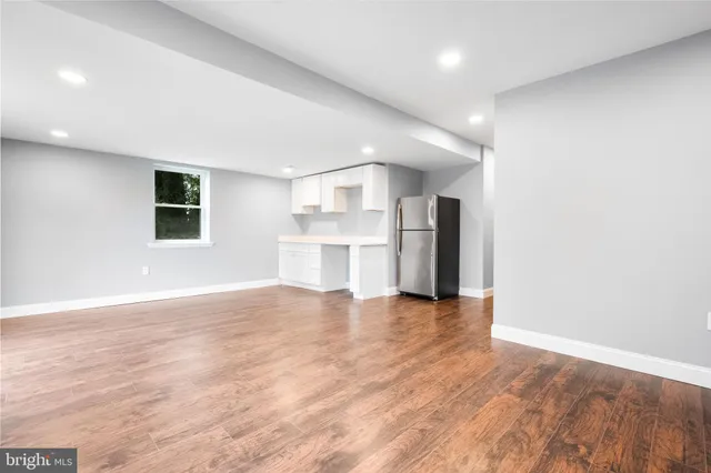 a view of a kitchen with a refrigerator and a stove top oven