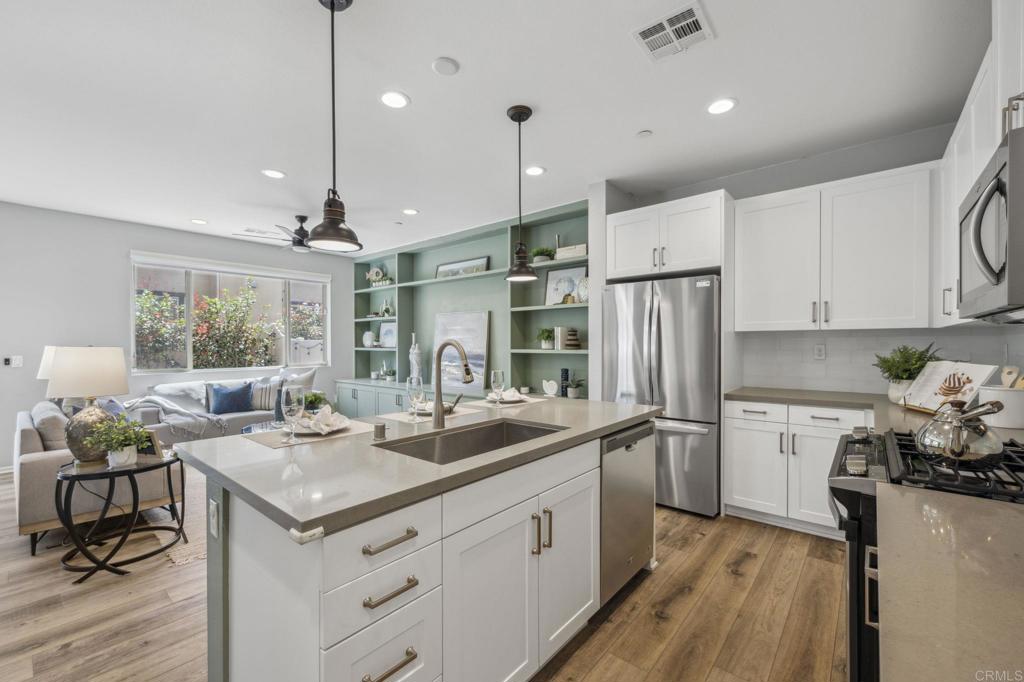 1167 Via Lucero Oceanside, CA 92056 - Photo 12 of 54 a kitchen with a sink appliances and cabinets