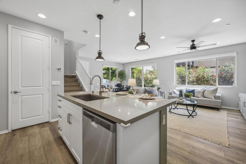 1167 Via Lucero Oceanside, CA 92056 - Photo 15 of 54 a kitchen with stainless steel appliances granite countertop a sink a stove and a wooden floor
