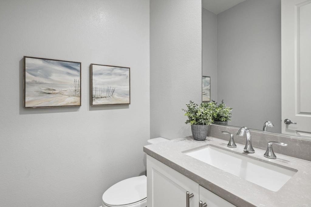 1167 Via Lucero Oceanside, CA 92056 - Photo 18 of 54 a bathroom with a granite countertop toilet sink and mirror