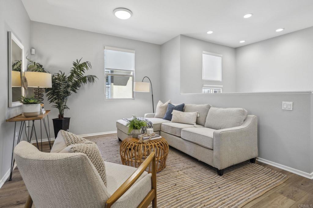 1167 Via Lucero Oceanside, CA 92056 - Photo 20 of 54 a living room with furniture and a wooden floor