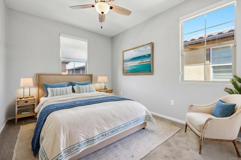 1167 Via Lucero Oceanside, CA 92056 - Photo 21 of 54 a bedroom with a bed and chair